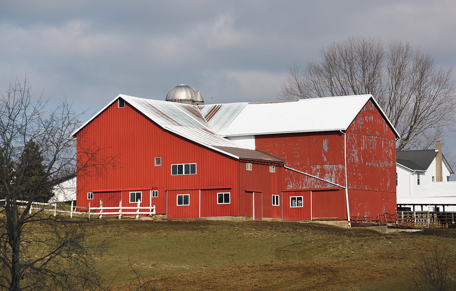A large red barn with a white roof.
