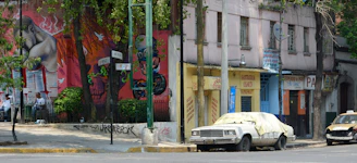 A vibrant street view of Córdoba city with local businesses and colorful murals.