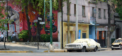 A vibrant street view of Córdoba city with local businesses and colorful murals.