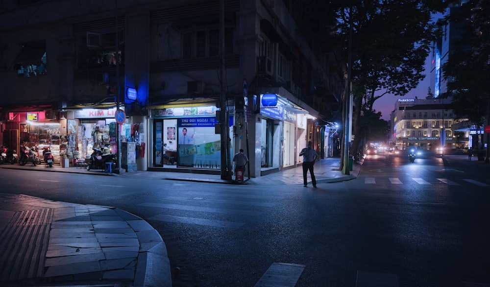 people walking on sidewalk during night time