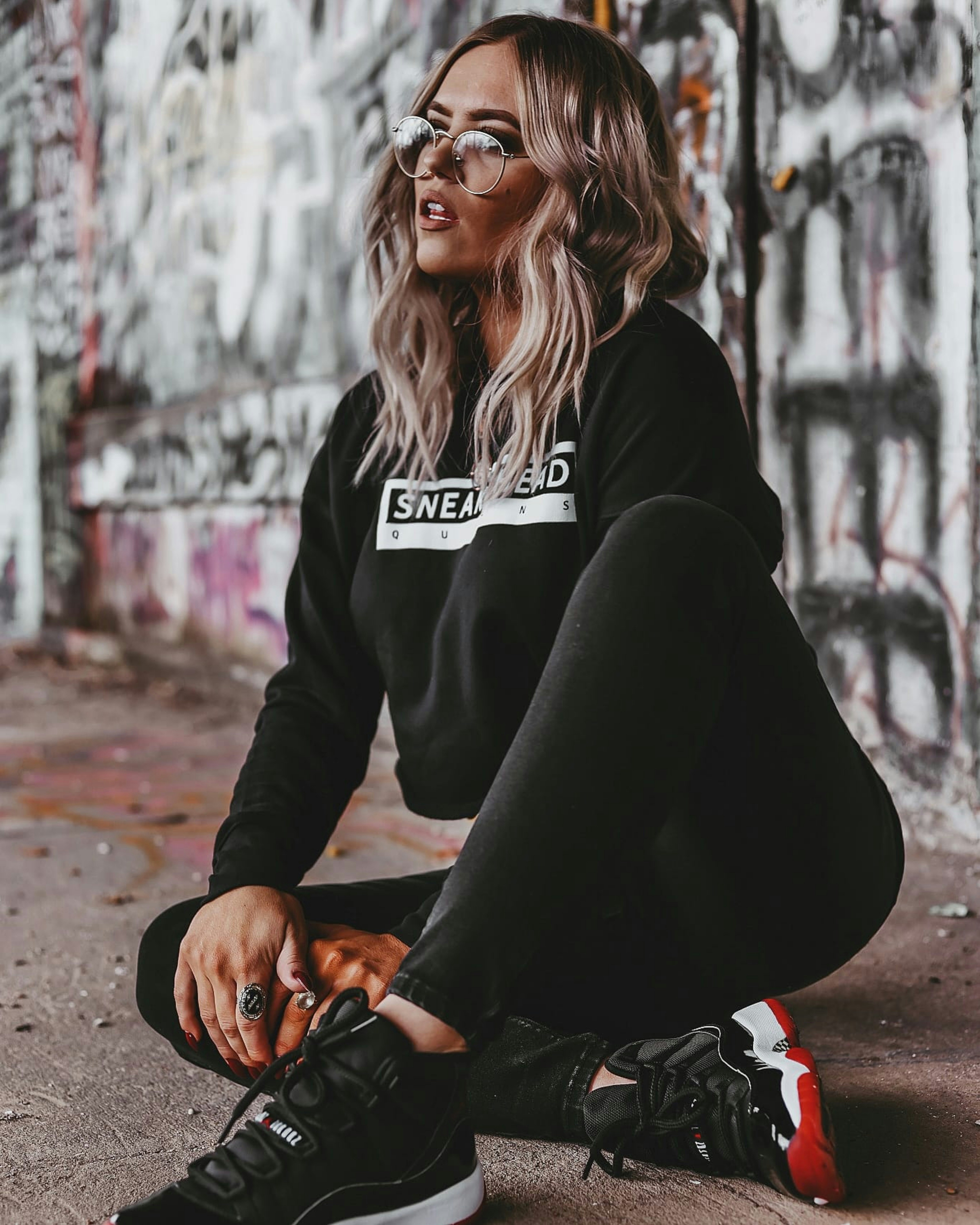 woman in black jacket and black pants sitting on ground