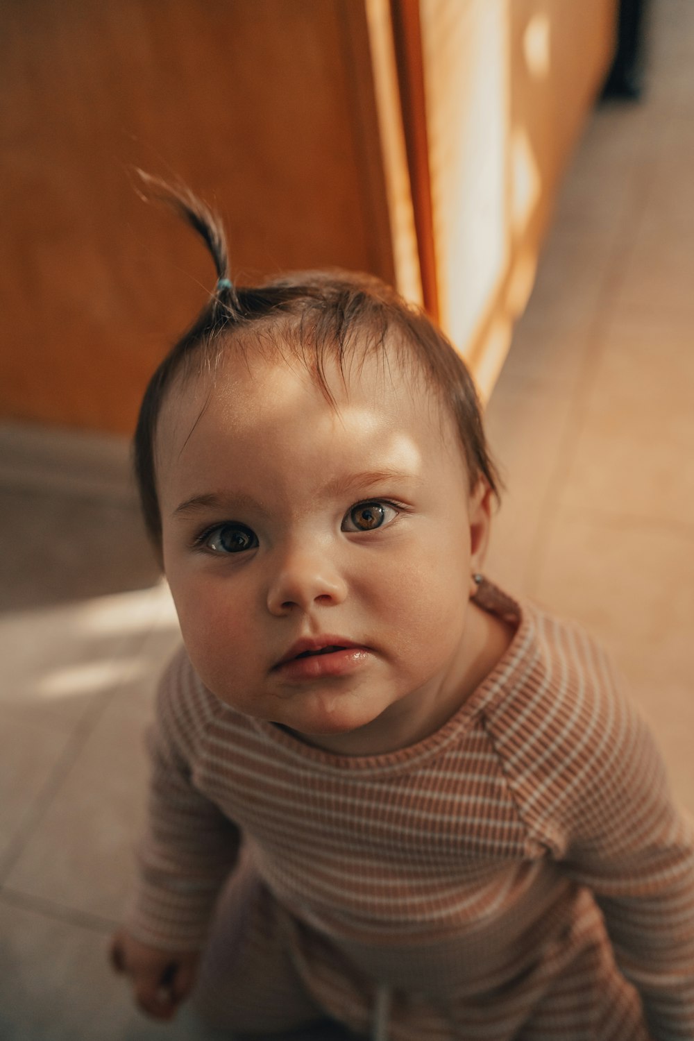 baby in white and black striped long sleeve shirt