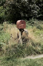 brown wooden post on green grass field during daytime