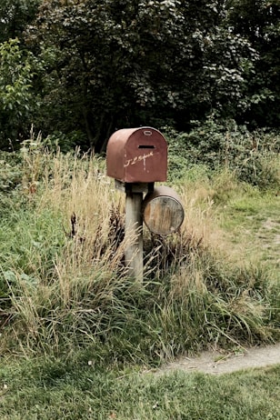 brown wooden post on green grass field during daytime