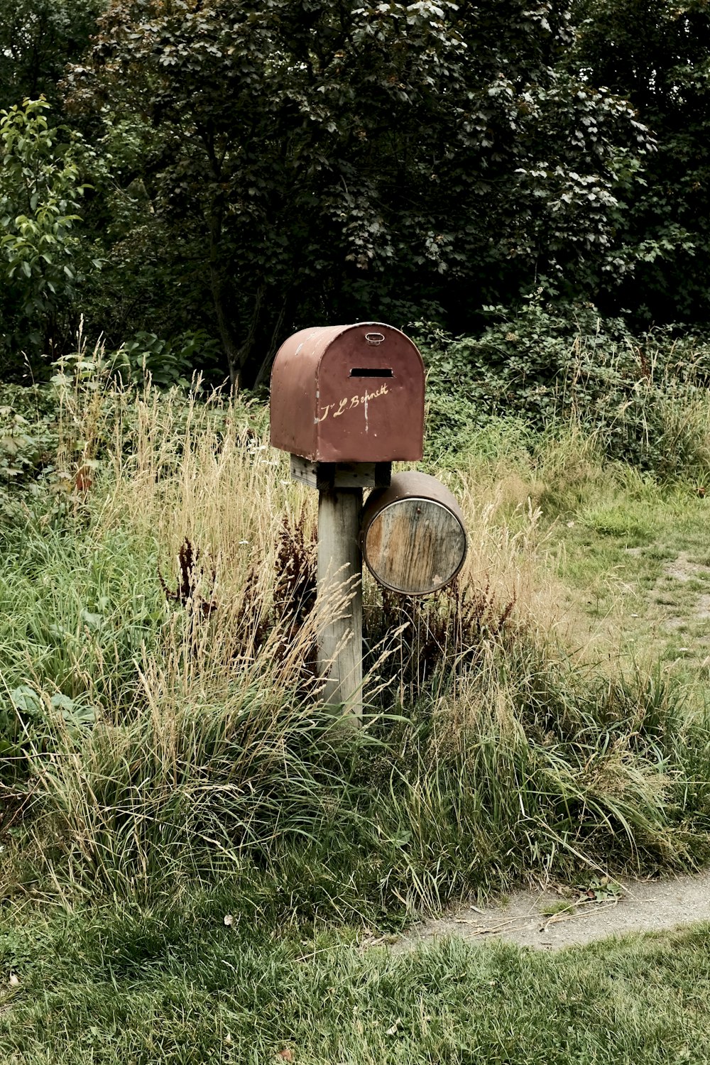 brown wooden post on green grass field during daytime