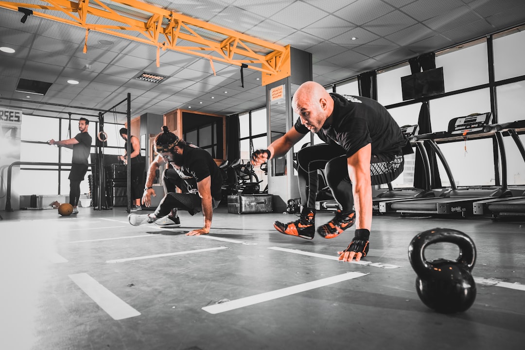 man in black tank top and black shorts doing exercise