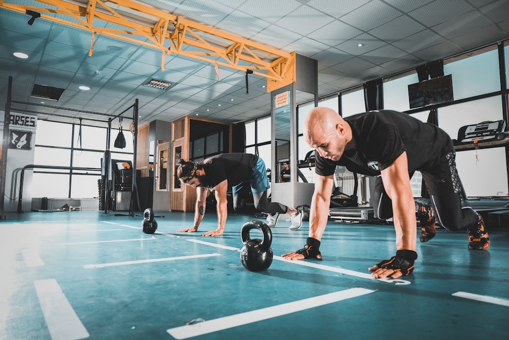 man in black tank top and black shorts doing exercise