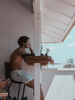 man in gray shorts sitting on chair