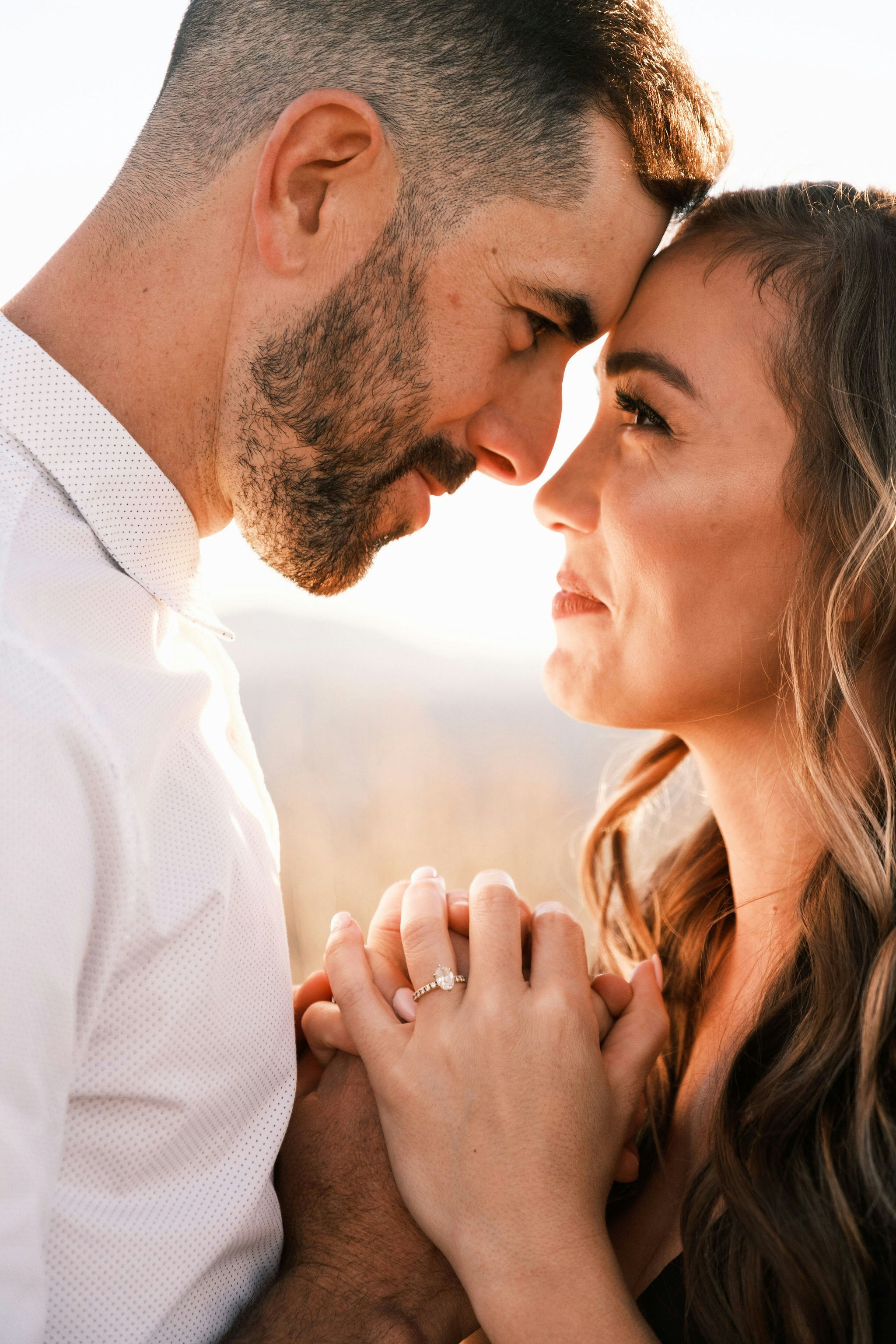 great photo recipe,how to photograph engagement  ; man in white dress shirt kissing woman in brown shirt