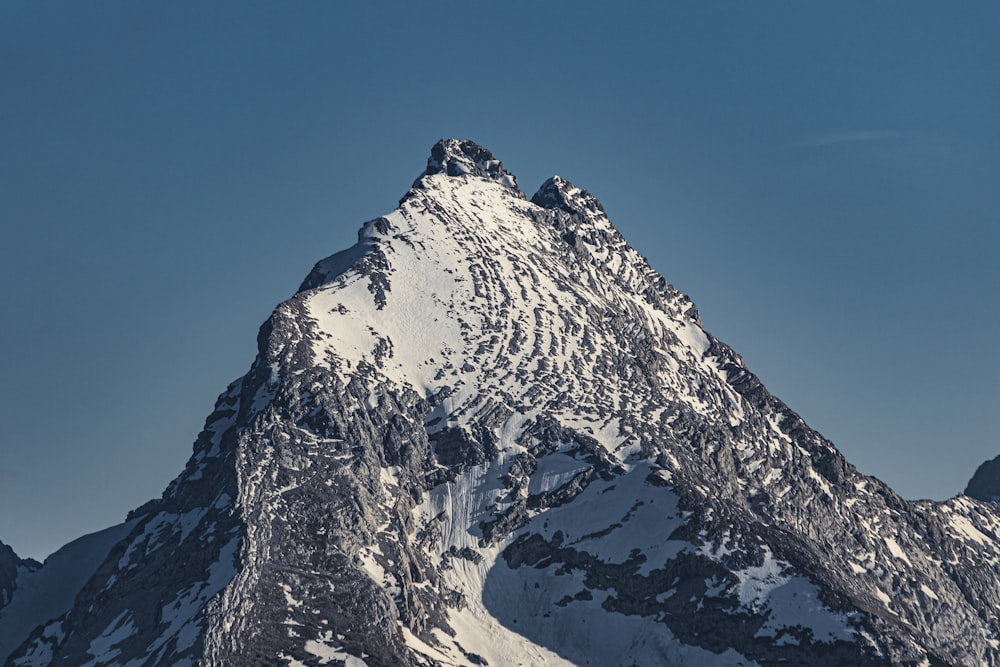 snow covered mountain under blue sky during daytime