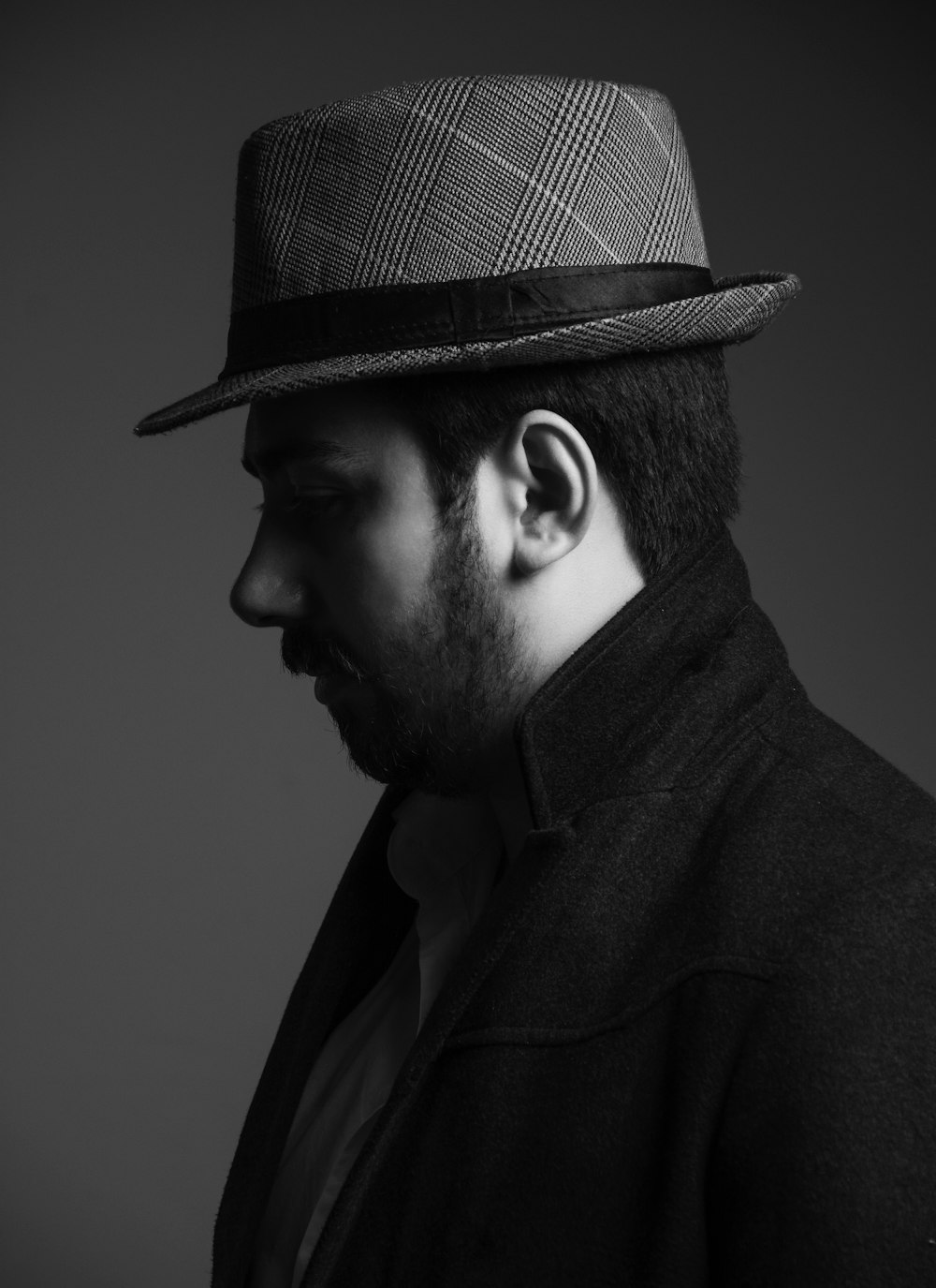man wearing hat in grayscale photography