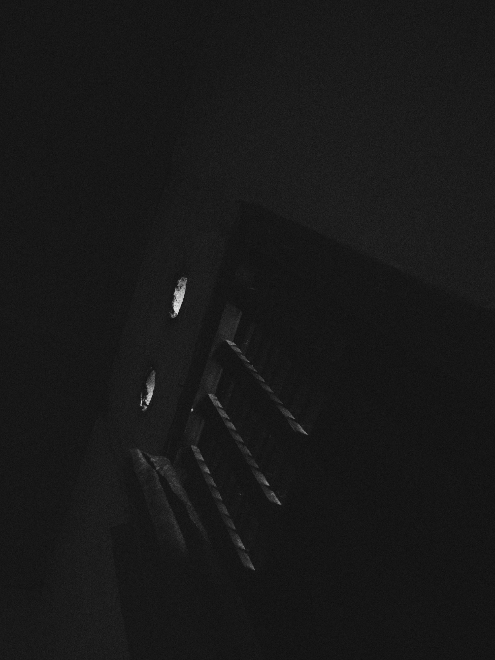 Players sprinting through a narrow corridor, adrenaline visible on their faces, as they race against time to escape the encroaching darkness.