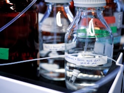 clear glass bottles on white table