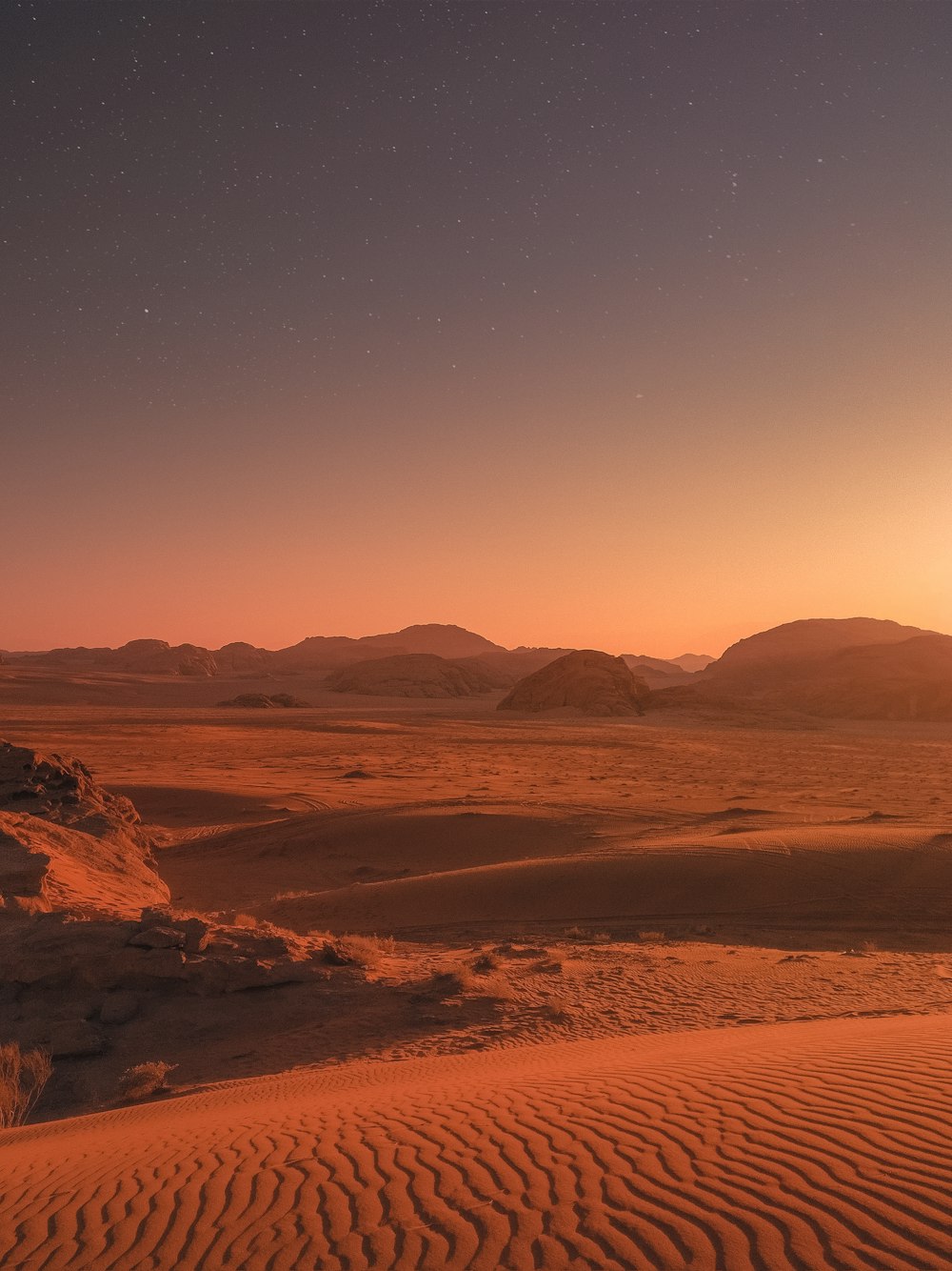 brown sand under blue sky during night time