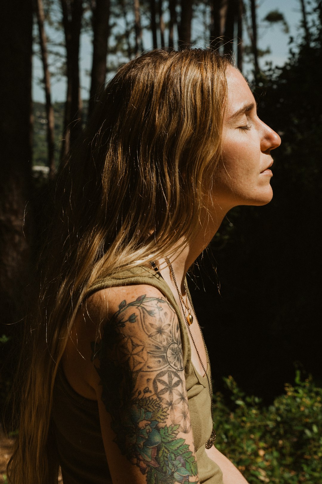 woman with black and brown floral tattoo on her back