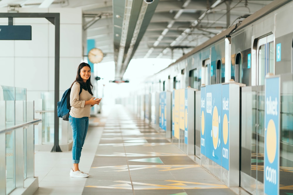 woman in black shirt and blue denim jeans standing on hallway