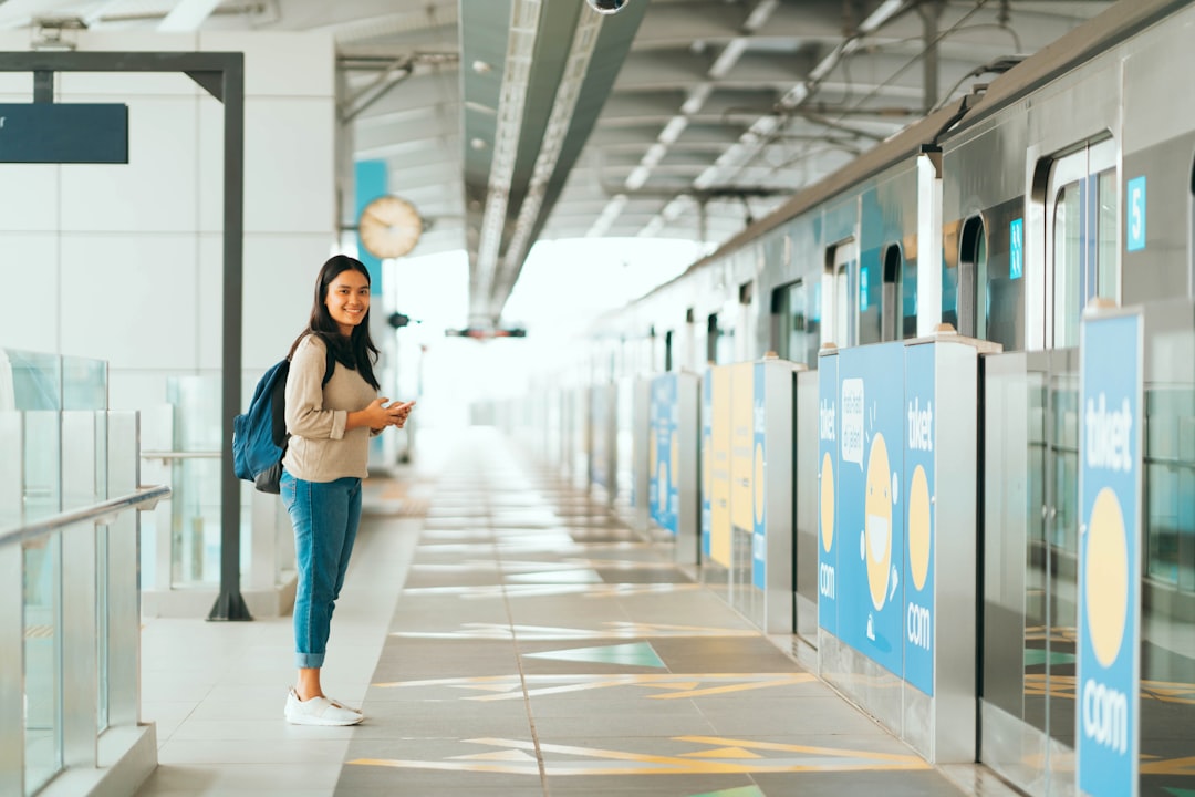 woman in black shirt and blue denim jeans standing on hallway, i see you :)
