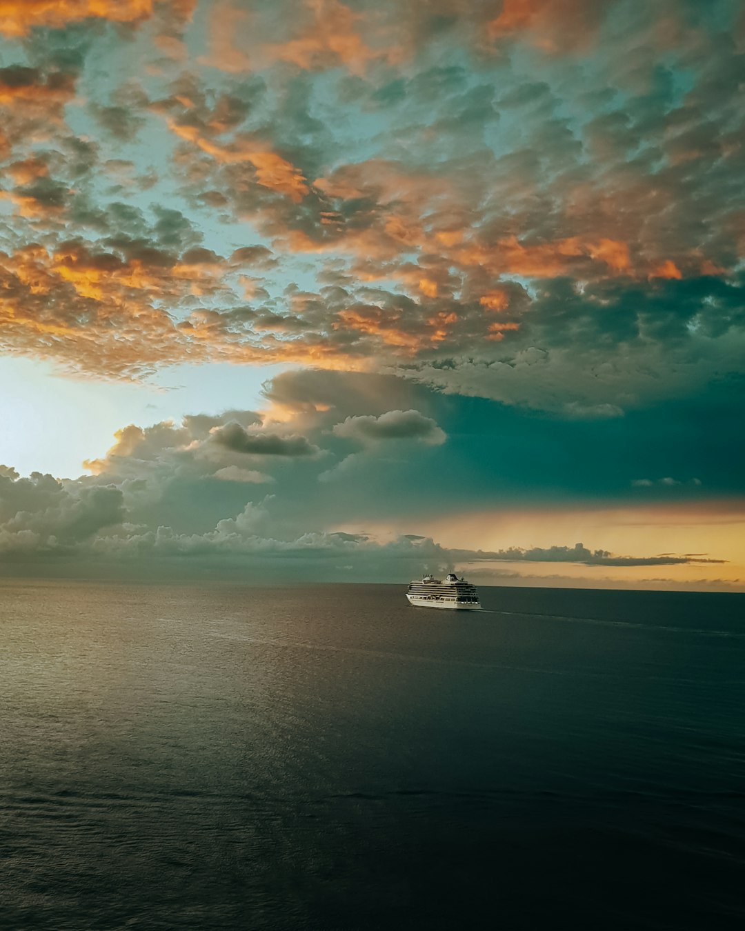 white boat on sea under blue sky and white clouds during daytime