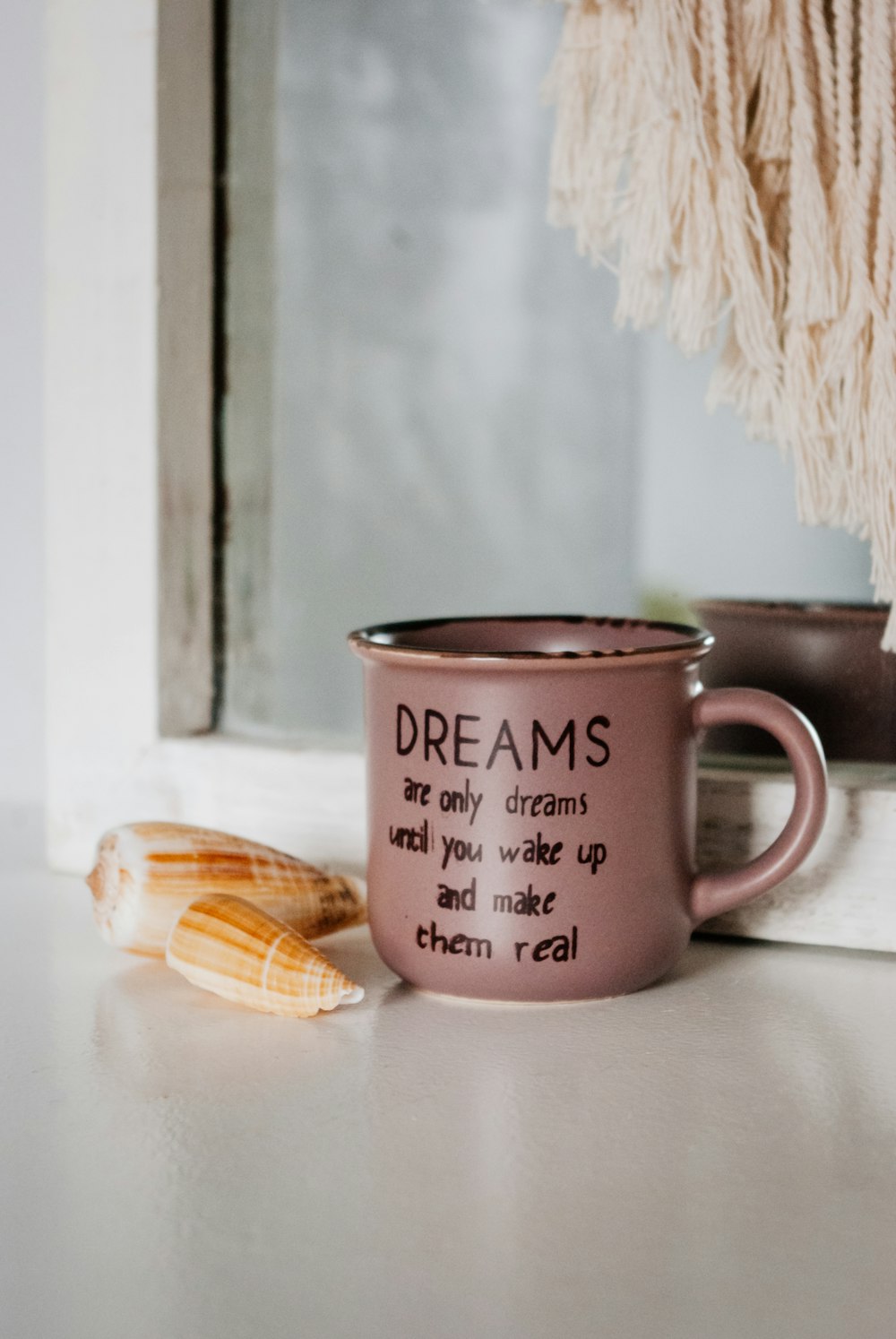 white ceramic mug beside brown wooden biscuit