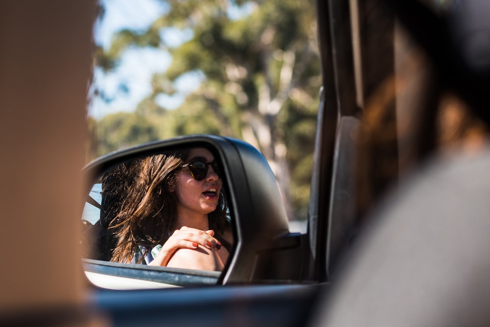 woman in black sunglasses inside car during daytime