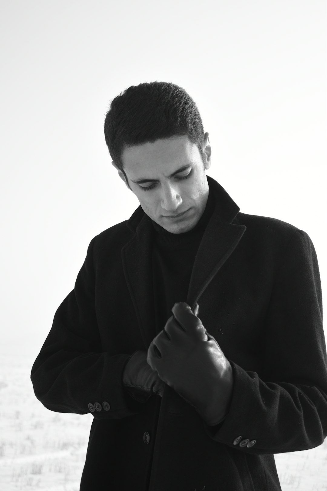 man in black coat holding a stick