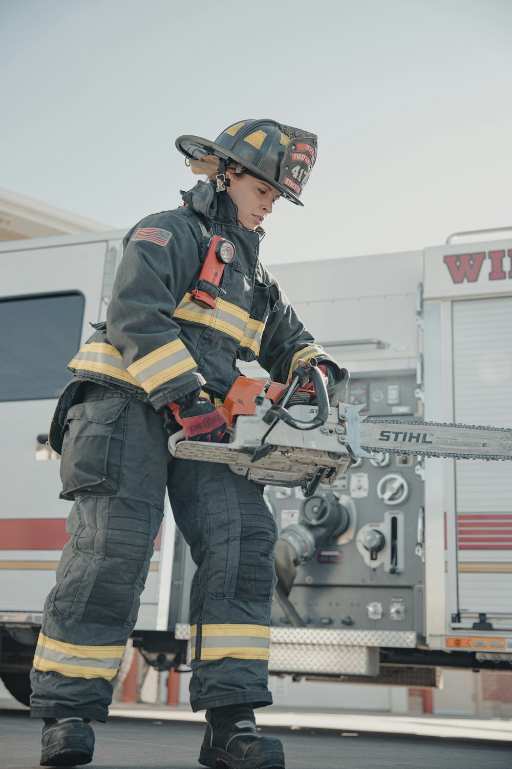 a firefighter standing in front of a fire truck