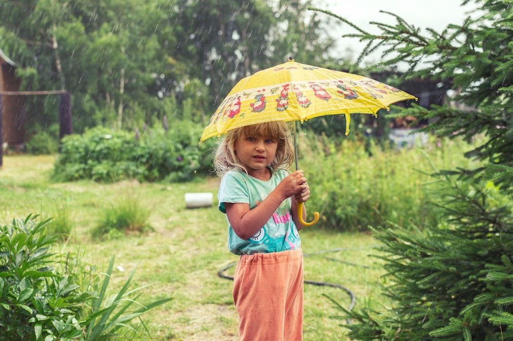 woman in blue and red dress holding umbrella