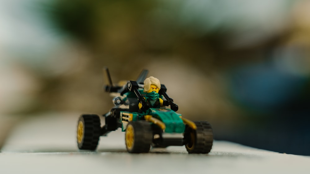 green and yellow lego toy