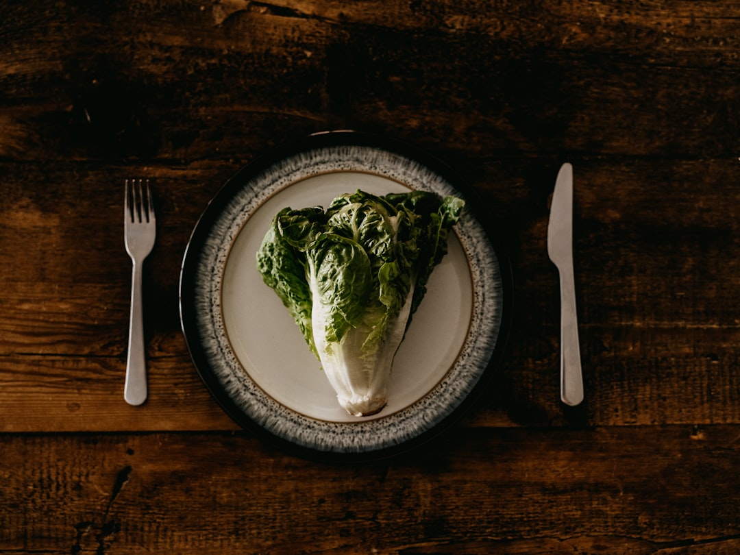 green vegetable on white and black ceramic plate