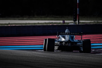 red and black f 1 race car on track during daytime