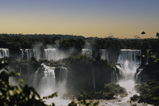 waterfalls under blue sky during daytime