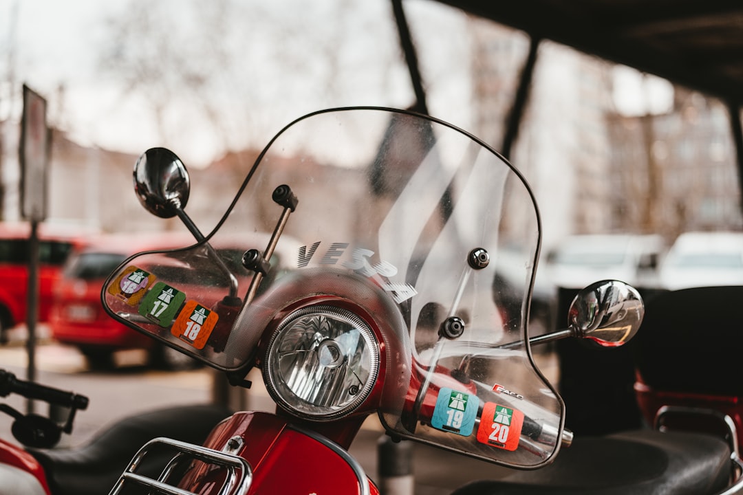 red and black motorcycle in front of black steering wheel