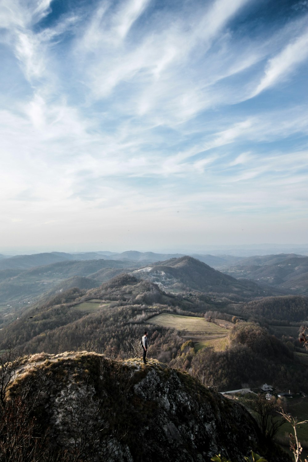 person standing on top of mountain during daytime