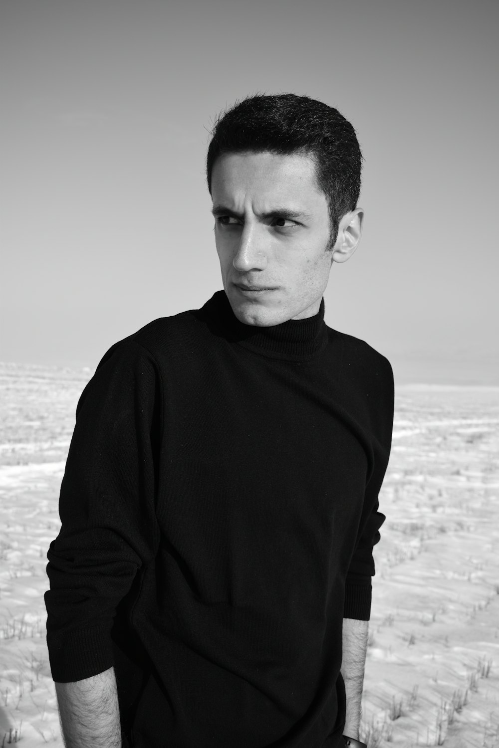 man in black long sleeve shirt standing on beach