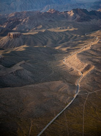 Aerial view of open brown desert and low mountains, the kind of undeveloped terrain that makes up the Eldorado Valley Transfer Area