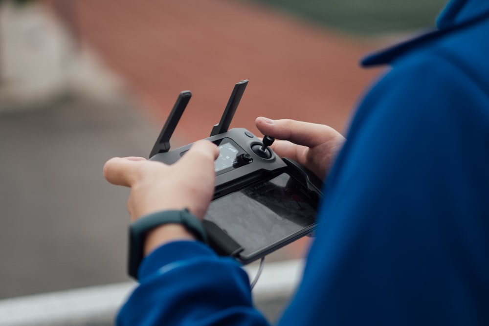 person holding black game controller