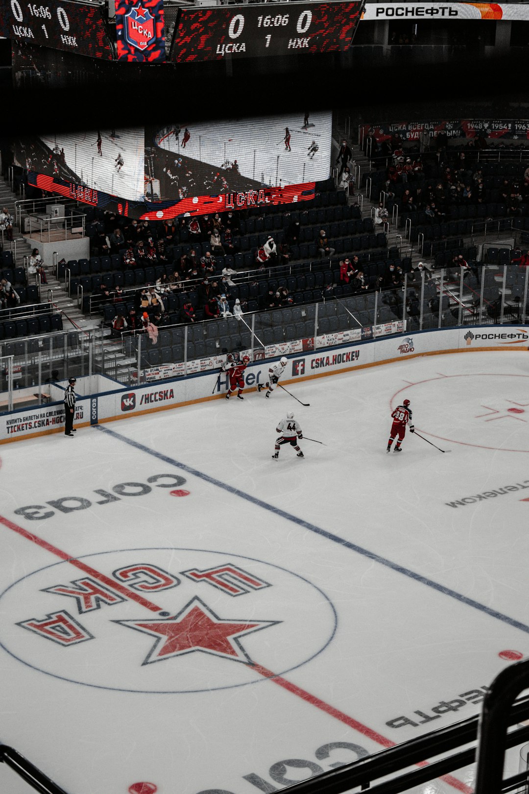 people playing ice hockey inside stadium