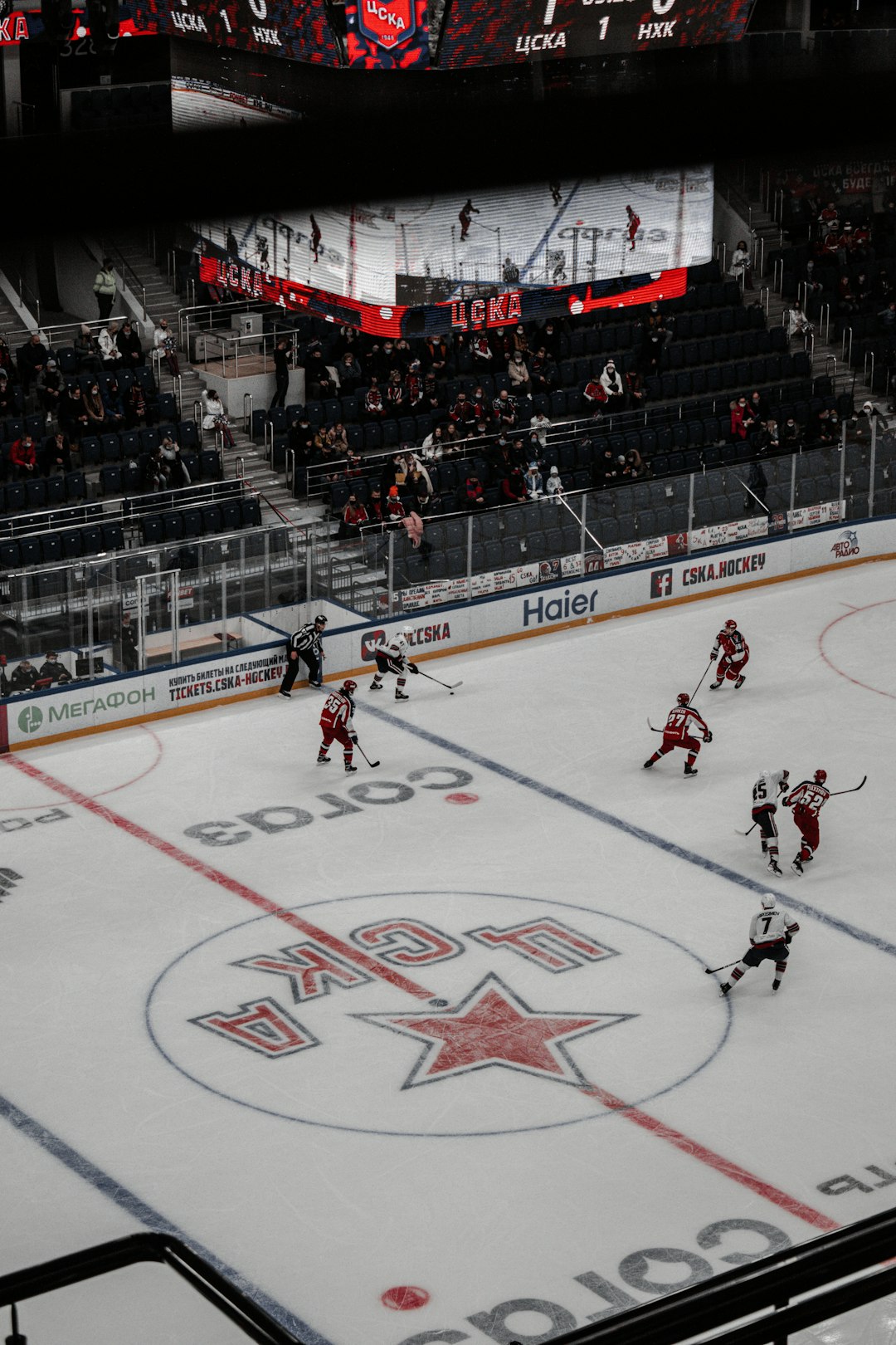 people playing ice hockey inside stadium