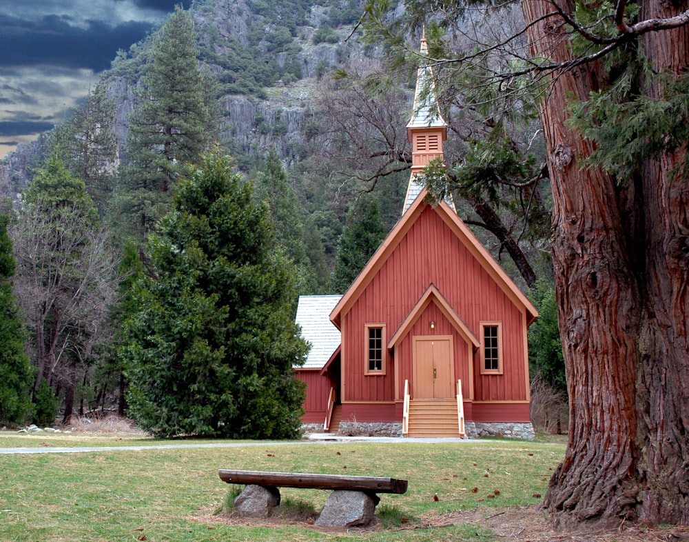 brown wooden bench near brown wooden church