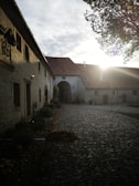 Artistic shot of a traditional Sicilian courtyard featuring rustic architecture bathed in warm light.