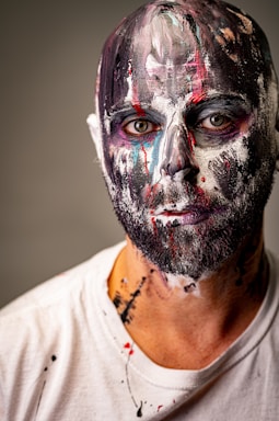 fine art photography,how to photograph portrait of a painter ; man in white crew neck shirt with face paint