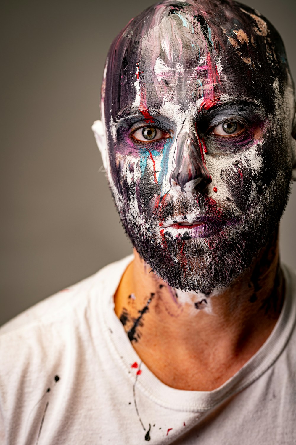 man in white crew neck shirt with face paint