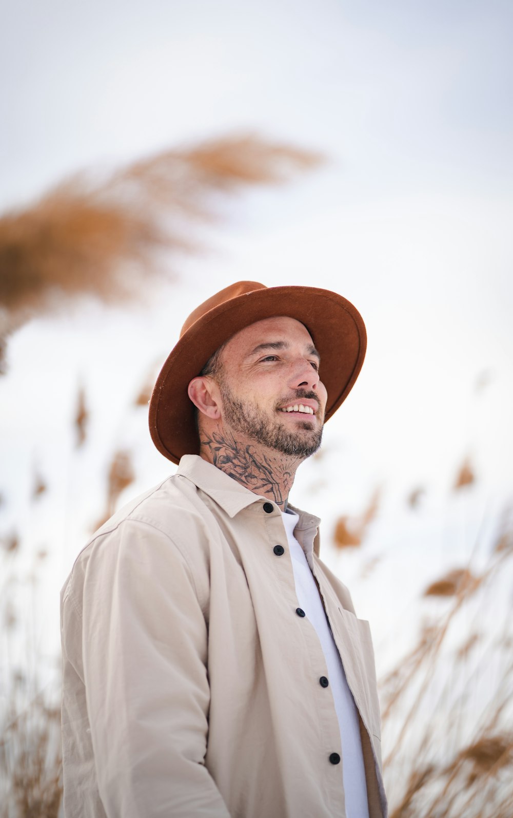 man in white button up shirt wearing brown hat