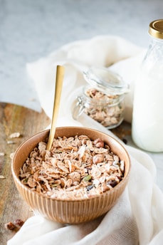 A cozy morning scene with a mom and child enjoying granola together by a sunlit kitchen window.