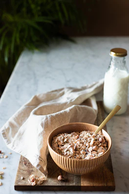 A sunlit morning scene with serum bottles and a wooden bowl of oats.