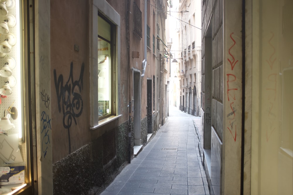 empty street between concrete buildings during daytime