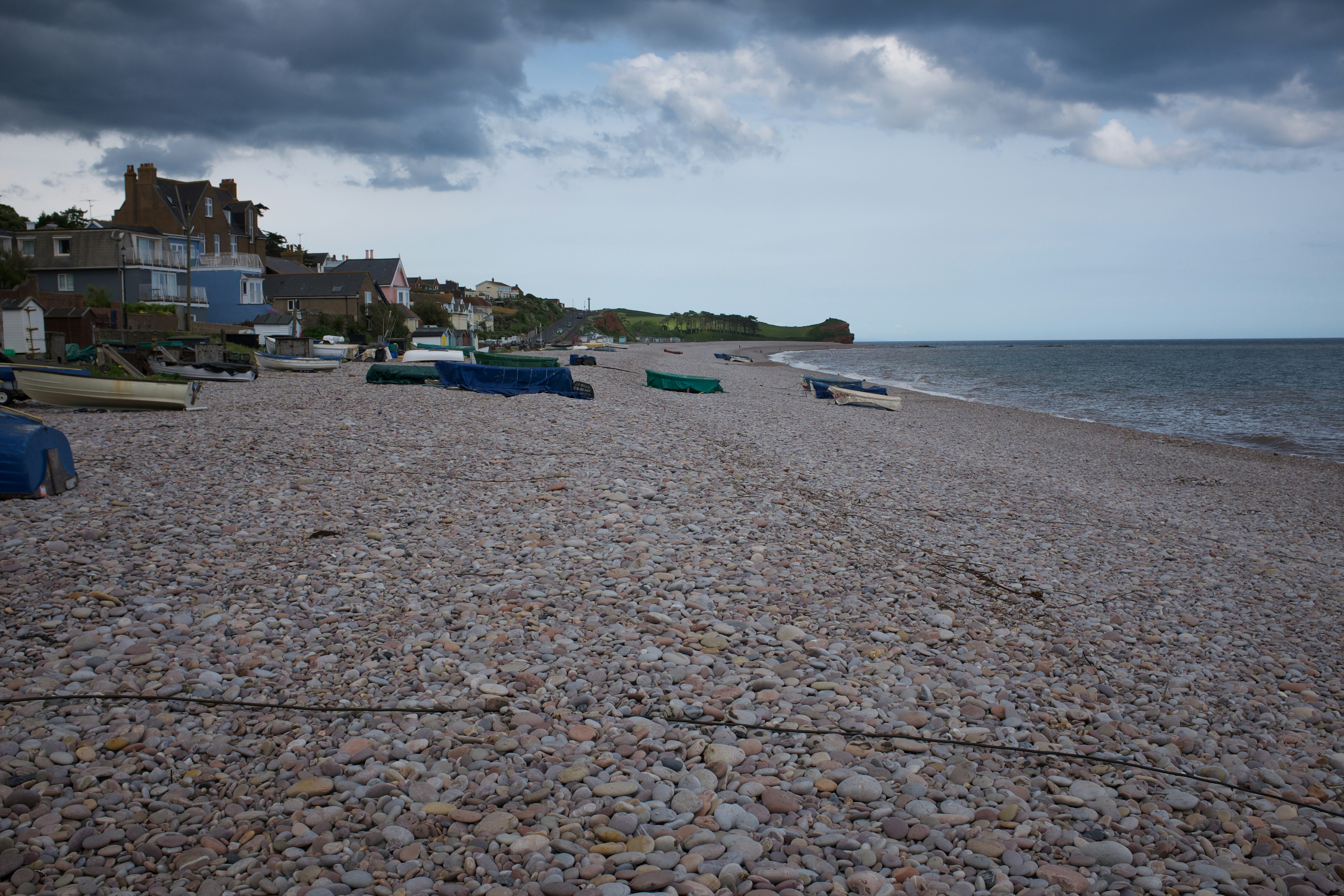 white and blue boats on sea shore during daytime