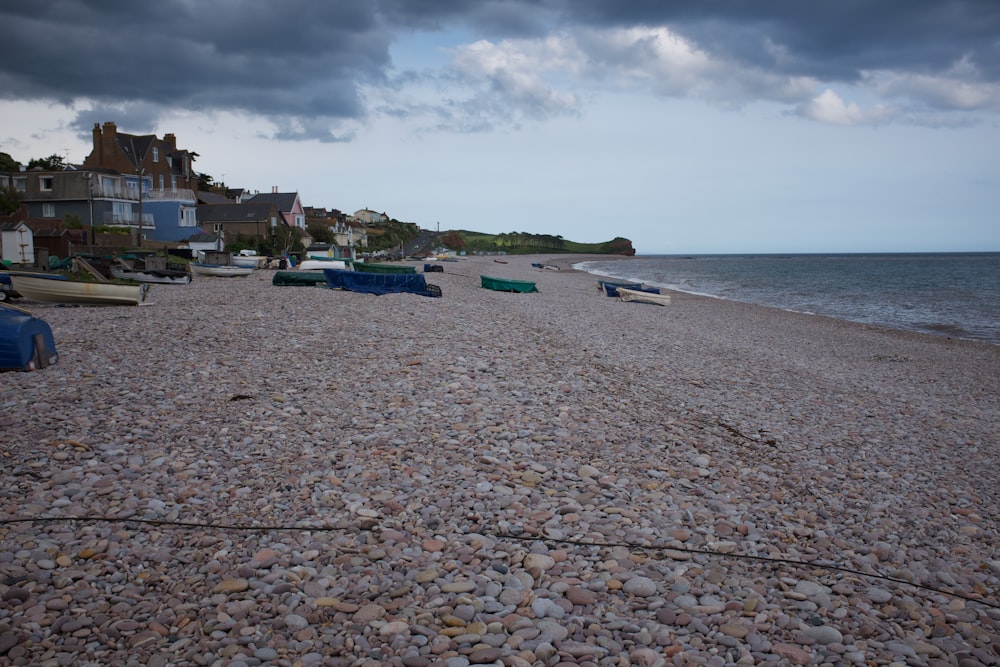 white and blue boats on sea shore during daytime