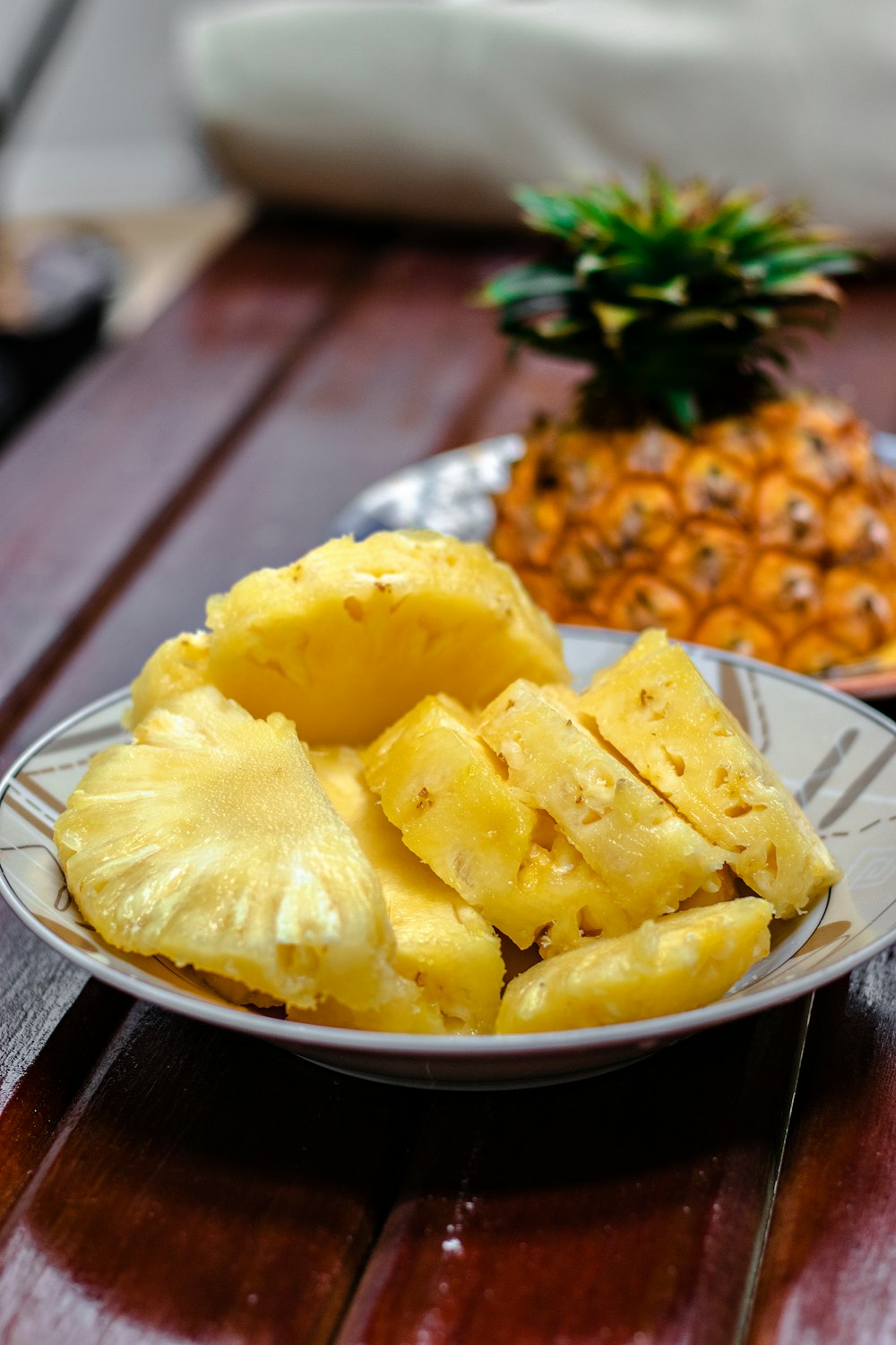 piña en rodajas sobre plato de cerámica blanca