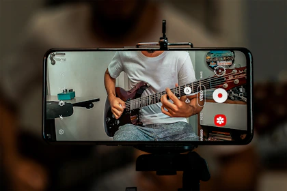 man in white crew neck t-shirt playing electric guitar